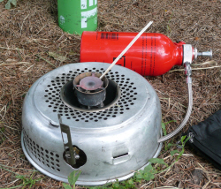 Picture showing Lighting the multi-fuel burner with a long wooden taper